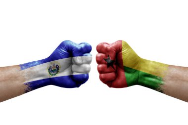 Two hands punch to each others on white background. Country flags painted fists, conflict crisis concept between el salvador and guinea-bissau