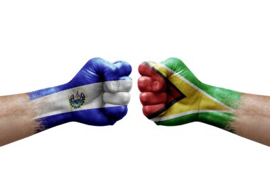 Two hands punch to each others on white background. Country flags painted fists, conflict crisis concept between el salvador and guyana