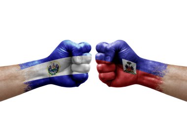 Two hands punch to each others on white background. Country flags painted fists, conflict crisis concept between el salvador and haiti
