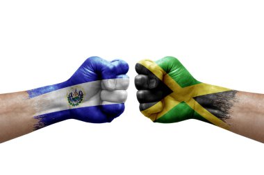 Two hands punch to each others on white background. Country flags painted fists, conflict crisis concept between el salvador and jamaica