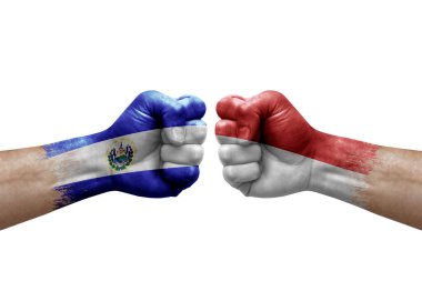 Two hands punch to each others on white background. Country flags painted fists, conflict crisis concept between el salvador and monaco