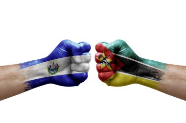 Two hands punch to each others on white background. Country flags painted fists, conflict crisis concept between el salvador and mozambique