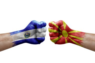 Two hands punch to each others on white background. Country flags painted fists, conflict crisis concept between el salvador and north macedonia