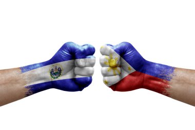 Two hands punch to each others on white background. Country flags painted fists, conflict crisis concept between el salvador and philippines