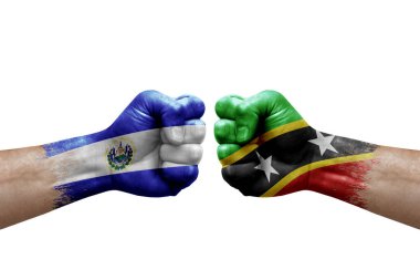 Two hands punch to each others on white background. Country flags painted fists, conflict crisis concept between el salvador and saint kitts and nevis