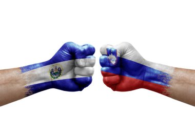Two hands punch to each others on white background. Country flags painted fists, conflict crisis concept between el salvador and slovenia