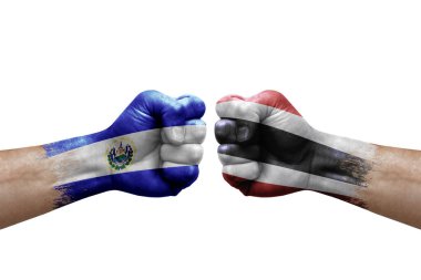 Two hands punch to each others on white background. Country flags painted fists, conflict crisis concept between el salvador and thailand