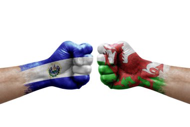 Two hands punch to each others on white background. Country flags painted fists, conflict crisis concept between el salvador and wales