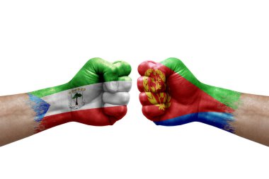 Two hands punch to each others on white background. Country flags painted fists, conflict crisis concept between equatorial guinea and eritrea