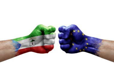 Two hands punch to each others on white background. Country flags painted fists, conflict crisis concept between equatorial guinea and european union