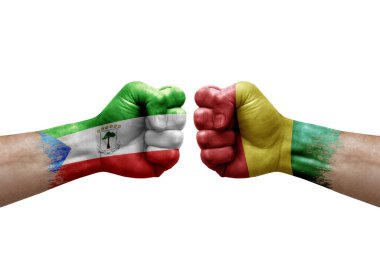 Two hands punch to each others on white background. Country flags painted fists, conflict crisis concept between equatorial guinea and guinea