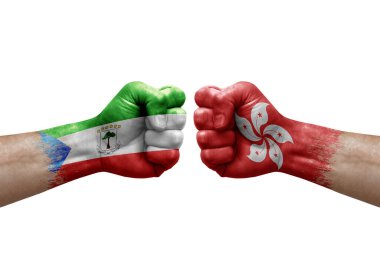 Two hands punch to each others on white background. Country flags painted fists, conflict crisis concept between equatorial guinea and hong kong