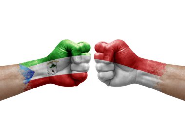 Two hands punch to each others on white background. Country flags painted fists, conflict crisis concept between equatorial guinea and indonesia