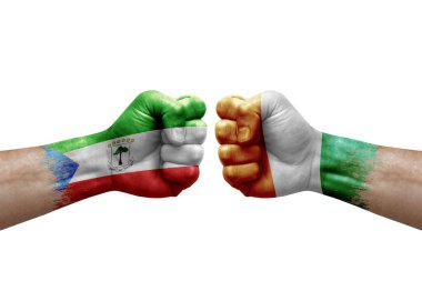 Two hands punch to each others on white background. Country flags painted fists, conflict crisis concept between equatorial guinea and ivory coast