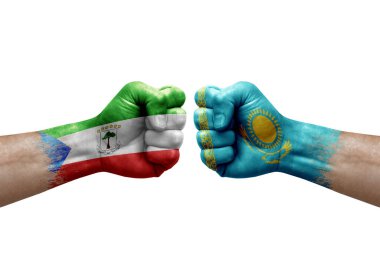 Two hands punch to each others on white background. Country flags painted fists, conflict crisis concept between equatorial guinea and kazakhstan