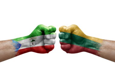 Two hands punch to each others on white background. Country flags painted fists, conflict crisis concept between equatorial guinea and lithuania