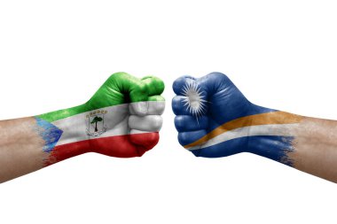 Two hands punch to each others on white background. Country flags painted fists, conflict crisis concept between equatorial guinea and marshall islands