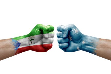 Two hands punch to each others on white background. Country flags painted fists, conflict crisis concept between equatorial guinea and micronesia