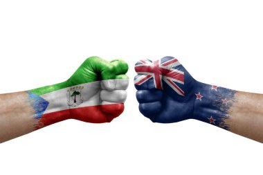 Two hands punch to each others on white background. Country flags painted fists, conflict crisis concept between equatorial guinea and new zealand