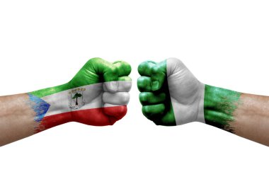 Two hands punch to each others on white background. Country flags painted fists, conflict crisis concept between equatorial guinea and nigeria