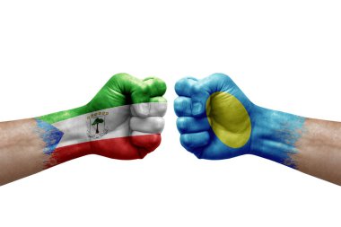 Two hands punch to each others on white background. Country flags painted fists, conflict crisis concept between equatorial guinea and palau