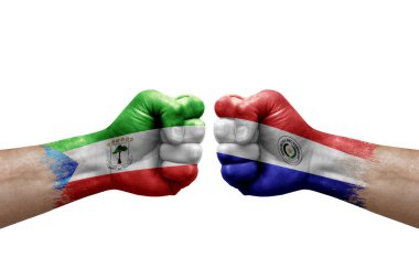 Two hands punch to each others on white background. Country flags painted fists, conflict crisis concept between equatorial guinea and paraguay