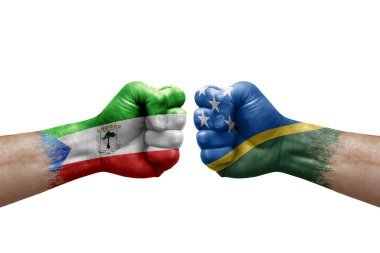 Two hands punch to each others on white background. Country flags painted fists, conflict crisis concept between equatorial guinea and solomon islands