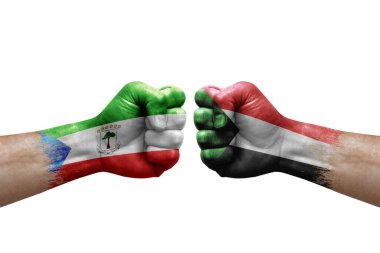 Two hands punch to each others on white background. Country flags painted fists, conflict crisis concept between equatorial guinea and sudan