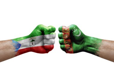 Two hands punch to each others on white background. Country flags painted fists, conflict crisis concept between equatorial guinea and turkmenistan