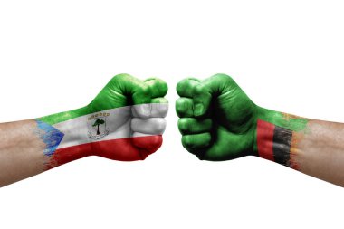 Two hands punch to each others on white background. Country flags painted fists, conflict crisis concept between equatorial guinea and zambia