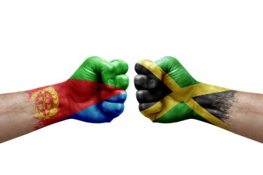 Two hands punch to each others on white background. Country flags painted fists, conflict crisis concept between eritrea and jamaica