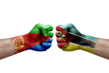 Two hands punch to each others on white background. Country flags painted fists, conflict crisis concept between eritrea and mozambique