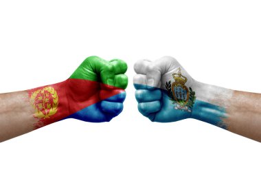 Two hands punch to each others on white background. Country flags painted fists, conflict crisis concept between eritrea and san marino