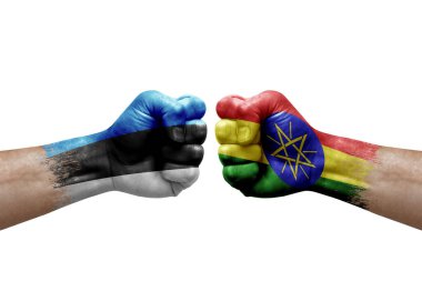 Two hands punch to each others on white background. Country flags painted fists, conflict crisis concept between estonia and ethiopia