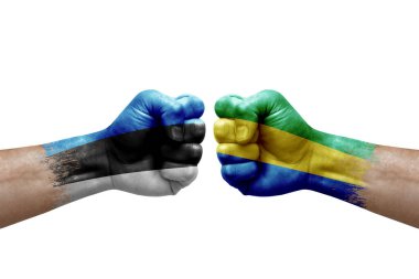 Two hands punch to each others on white background. Country flags painted fists, conflict crisis concept between estonia and gabon