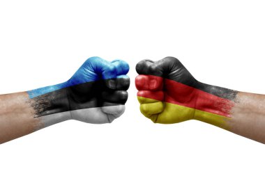 Two hands punch to each others on white background. Country flags painted fists, conflict crisis concept between estonia and germany