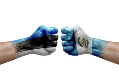 Two hands punch to each others on white background. Country flags painted fists, conflict crisis concept between estonia and guatemala