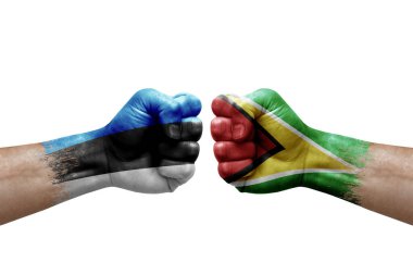 Two hands punch to each others on white background. Country flags painted fists, conflict crisis concept between estonia and guyana