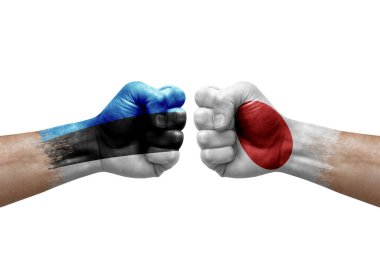 Two hands punch to each others on white background. Country flags painted fists, conflict crisis concept between estonia and japan