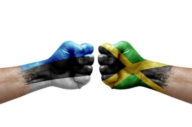 Two hands punch to each others on white background. Country flags painted fists, conflict crisis concept between estonia and jamaica