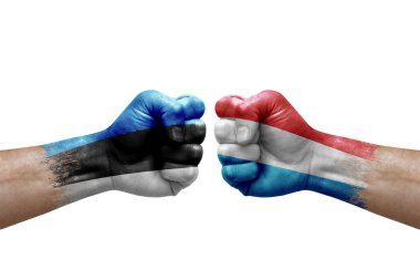 Two hands punch to each others on white background. Country flags painted fists, conflict crisis concept between estonia and luxembourg