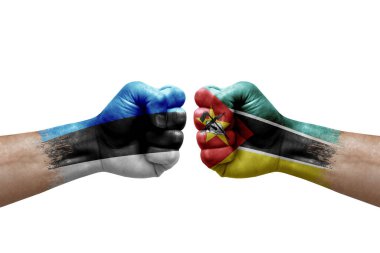 Two hands punch to each others on white background. Country flags painted fists, conflict crisis concept between estonia and mozambique