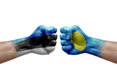Two hands punch to each others on white background. Country flags painted fists, conflict crisis concept between estonia and palau