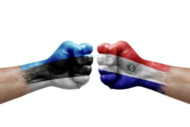 Two hands punch to each others on white background. Country flags painted fists, conflict crisis concept between estonia and paraguay