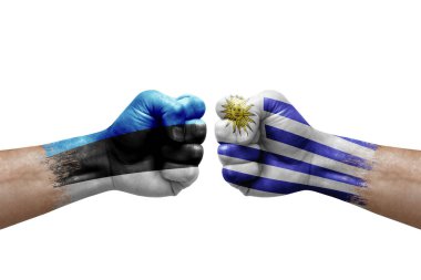 Two hands punch to each others on white background. Country flags painted fists, conflict crisis concept between estonia and uruguay