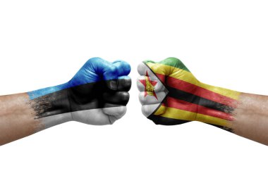 Two hands punch to each others on white background. Country flags painted fists, conflict crisis concept between estonia and zimbabwe