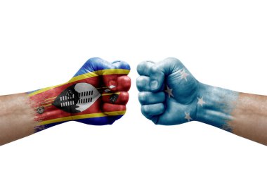 Two hands punch to each others on white background. Country flags painted fists, conflict crisis concept between eswatini and micronesia
