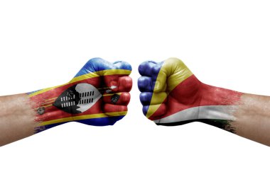 Two hands punch to each others on white background. Country flags painted fists, conflict crisis concept between eswatini and seychelles