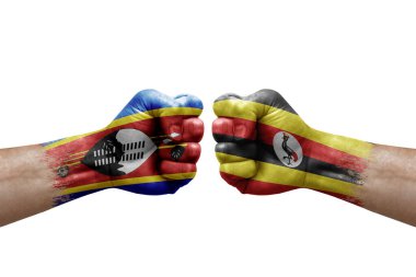 Two hands punch to each others on white background. Country flags painted fists, conflict crisis concept between eswatini and uganda