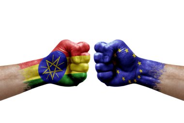 Two hands punch to each others on white background. Country flags painted fists, conflict crisis concept between ethiopia and european union